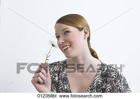 portrait of young woman smelling flower View Large Photo Image Stock Image - portrait of young woman smelling flower. Fotosearch