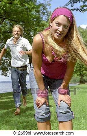 portrait of young woman with man joining in the background View Large Photo Image Stock Image - portrait of young woman with man joining in the background. Fotosearch