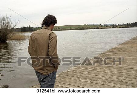 rear view of man walking on pier View Large Photo Image Stock Image - rear view of man walking on pier. Fotosearch