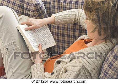 rear view of woman reading book on sofa View Large Photo Image Stock Image - rear view of woman reading book on sofa. Fotosearch