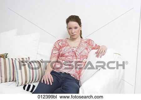 sad looking teenager sitting on couch View Large Photo Image Stock Image - sad looking teenager sitting on couch. Fotosearch