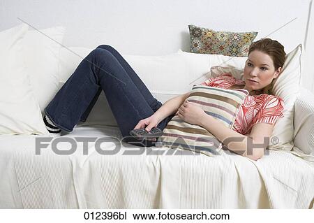 sad looking teenager watching tv from sofa View Large Photo Image Stock Image - sad looking teenager watching tv from sofa. Fotosearch