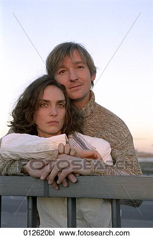 serious looking woman embraced by her partner View Large Photo Image Stock Image - serious looking woman embraced by her partner. Fotosearch