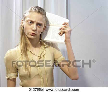 seroius looking girl listening to audio book View Large Photo Image Stock Image - seroius looking girl listening to audio book. Fotosearch
