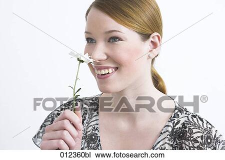 smiling teenage girl smelling on flower View Large Photo Image Stock Image - smiling teenage girl smelling on flower. Fotosearch