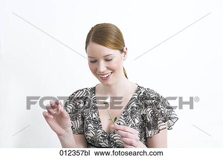 smiling woman plucking flower petals View Large Photo Image Stock Image - smiling woman plucking flower petals. Fotosearch