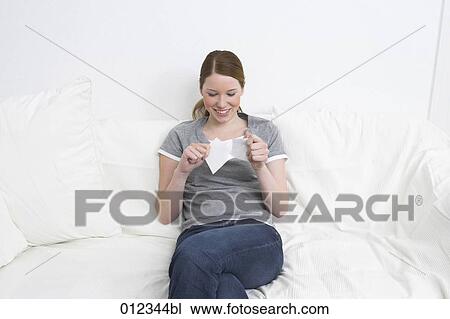 smiling young woman tearing up photographs View Large Photo Image Stock Image - smiling young woman tearing up photographs. Fotosearch