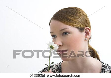 thoughtful looking teenage girl smelling flower View Large Photo Image Stock Image - thoughtful looking teenage girl smelling flower. Fotosearch