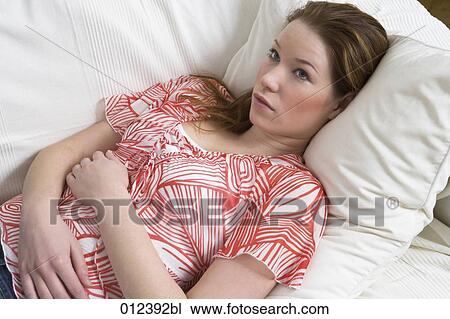 thoughtful looking woman lying on couch View Large Photo Image Stock Image - thoughtful looking woman lying on couch. Fotosearch