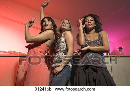 three young women having fun in nightclub View Large Photo Image Stock Image - three young women having fun in nightclub. Fotosearch