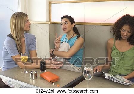 two friends having a conversation in restaurant View Large Photo Image Stock Image - two friends having a conversation in restaurant. Fotosearch