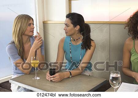 two friends having a serious conversation in restaurant View Large Photo Image Stock Image - two friends having a serious conversation in restaurant. Fotosearch