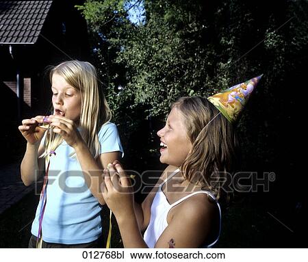 Stock Image - two girls doing preparations for garden party. Fotosearch