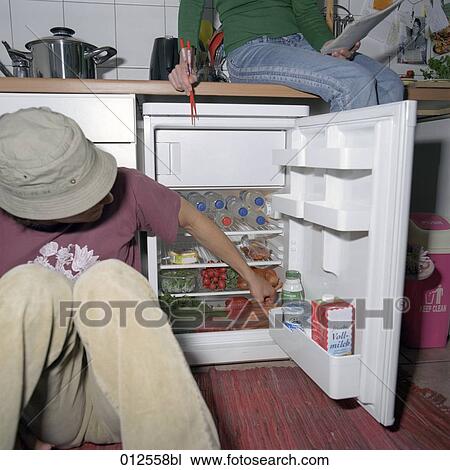 two people checking the content of their refrigerator View Large Photo Image Stock Image - two people checking the content of their refrigerator. Fotosearch