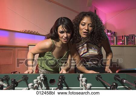 two young females playing tabletop soccer View Large Photo Image Stock Image - two young females playing tabletop soccer. Fotosearch