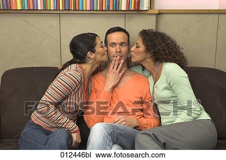 two young women kissing their male friend View Large Photo Image Stock Image - two young women kissing their male friend. Fotosearch
