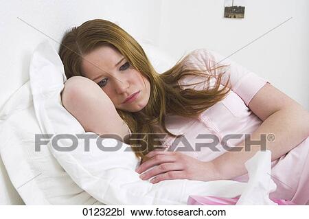 unhappy young woman lying in bed View Large Photo Image Stock Image - unhappy young woman lying in bed. Fotosearch