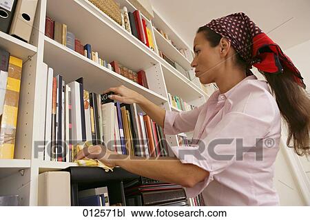 woman dusting bookshelf View Large Photo Image Stock Image - woman dusting bookshelf. Fotosearch