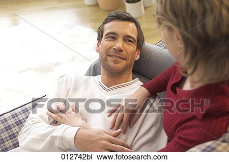 woman looking down on man lying on sofa View Large Photo Image Stock Image - woman looking down on man lying on sofa. Fotosearch