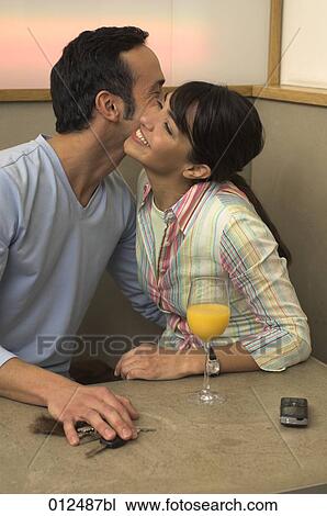 young couple embracing each other in restaurant View Large Photo Image Stock Image - young couple embracing each other in restaurant. Fotosearch