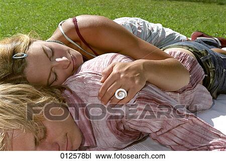 young couple sleeping in grass View Large Photo Image Stock Image - young couple sleeping in grass. Fotosearch