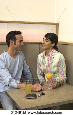 young couple talking in restaurant View Large Photo Image Stock Image - young couple talking in restaurant. Fotosearch