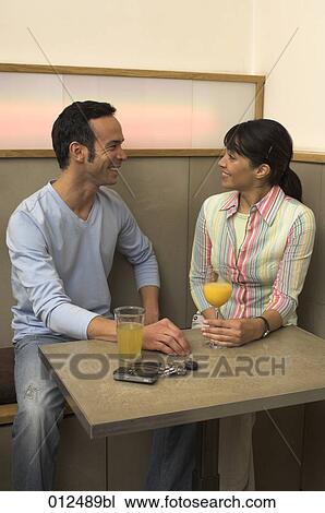 young woman and her gay friend sharing a smile in restaurant View Large Photo Image Stock Image - young woman and her gay friend sharing a smile in restaurant. Fotosearch