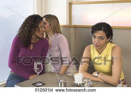 young woman in cafe enervated by her whispering friends View Large Photo Image Stock Image - young woman in cafe enervated by her whispering friends. Fotosearch