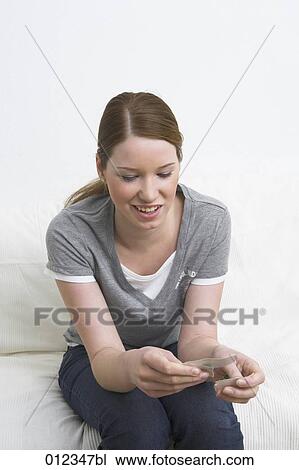 young woman looking at ripped up photograph View Large Photo Image Stock Image - young woman looking at ripped up photograph. Fotosearch