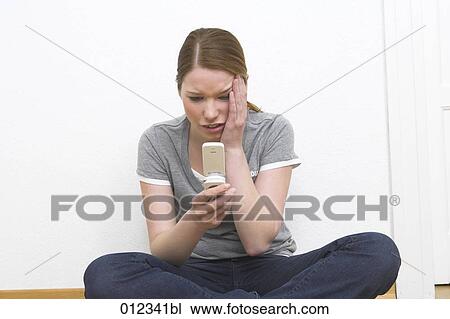 young woman receiving shocking text message View Large Photo Image Stock Image - young woman receiving shocking text message. Fotosearch