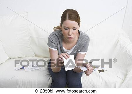 young woman sitting amongst papers tearing up photograph View Large Photo Image Stock Image - young woman sitting amongst papers tearing up photograph. Fotosearch