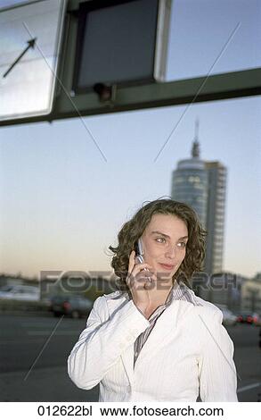 young woman talking on her cellphone amidst traffic on bridge View Large Photo Image Stock Image - young woman talking on her cellphone amidst traffic on bridge. Fotosearch