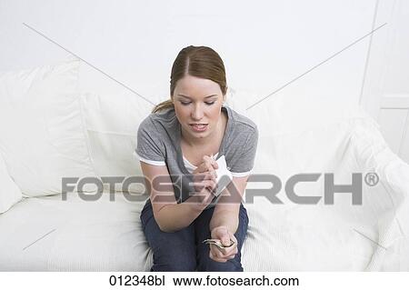 young woman tearing up photographs with a determined gesture View Large Photo Image Stock Image - young woman tearing up photographs with a determined gesture. Fotosearch