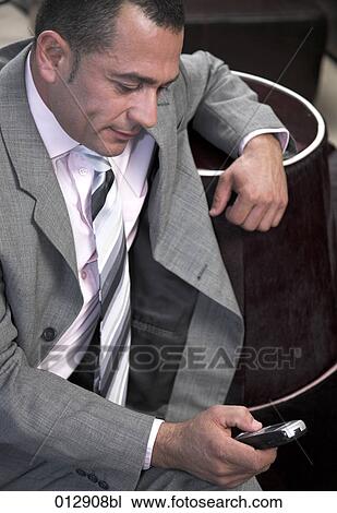 businessman looking at display of his mobile phone View Large Photo Image Stock Image - businessman looking at display of his mobile phone. Fotosearch