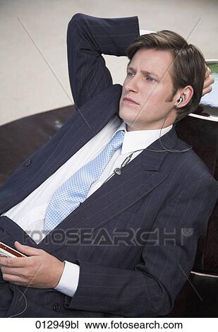 businessman with thoughtful expression listening to his ipod View Large Photo Image Stock Image - businessman with thoughtful expression listening to his ipod. Fotosearch