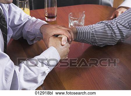 close-up of two businessman shaking hands View Large Photo Image Stock Image - close-up of two businessman shaking hands. Fotosearch