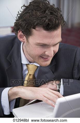 close-up of young businessman working with notebook computer View Large Photo Image Stock Image - close-up of young businessman working with notebook computer. Fotosearch