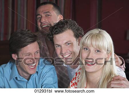 Stock Image - four friends posing for a portrait. Fotosearch