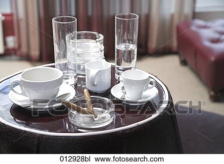 glasses, coffee cups and ashtray with cigars on tray View Large Photo Image Stock Image - glasses, coffee cups and ashtray with cigars on tray. Fotosearch