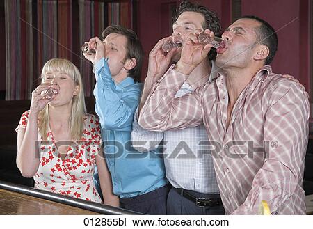 group of four friends gulping down drinks at bar View Large Photo Image Stock Image - group of four friends gulping down drinks at bar. Fotosearch