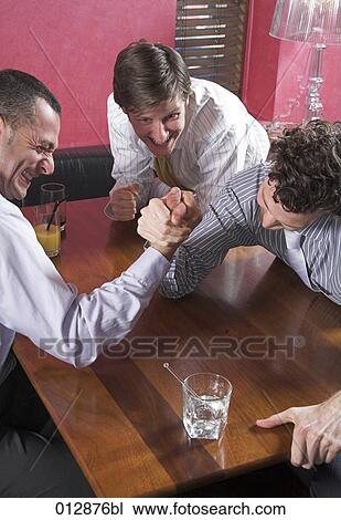 group of friends arm wrestling in bar View Large Photo Image Stock Image - group of friends arm wrestling in bar. Fotosearch