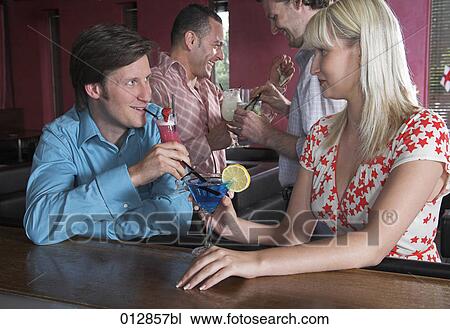 group of friends at bar young with couple flirting with each other View Large Photo Image Stock Image - group of friends at bar young with couple flirting with each other. Fotosearch