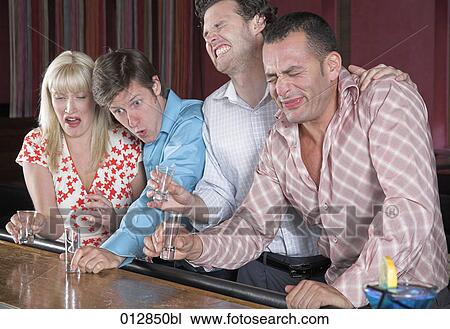 group of friends pulling faces after having hard drink at bar View Large Photo Image Stock Image - group of friends pulling faces after having hard drink at bar. Fotosearch