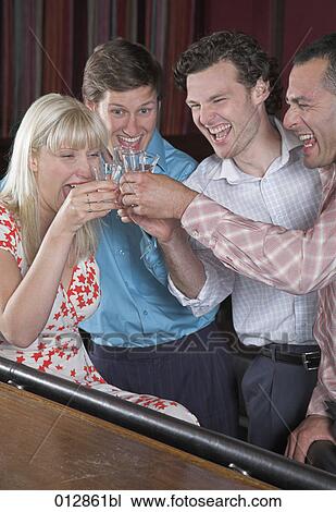 group of friends raising their glasses at bar View Large Photo Image Stock Image - group of friends raising their glasses at bar. Fotosearch
