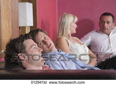 Stock Image - group of friends relaxing in nightclub. Fotosearch