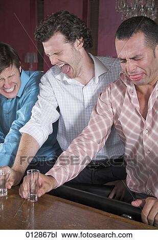 group of three friends making grimaces after having hard drinks View Large Photo Image Stock Image - group of three friends making grimaces after having hard drinks. Fotosearch
