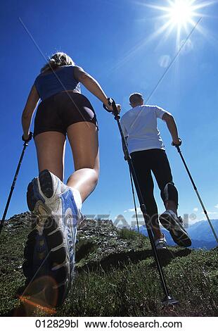low angle view of young couple doing nordic walking in mountain landscape View Large Photo Image Stock Image - low angle view of young couple doing nordic walking in mountain landscape. Fotosearch