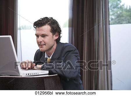 portrait of businessman working with his laptop computer View Large Photo Image Stock Image - portrait of businessman working with his laptop computer. Fotosearch