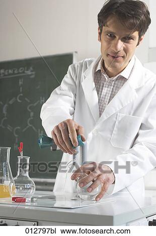 portrait of chemist doing an experiment in laboratory View Large Photo Image Stock Image - portrait of chemist doing an experiment in laboratory. Fotosearch