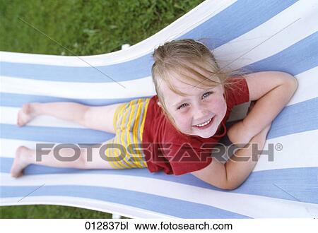 portrait of happy little girl relaxing on sunlounger View Large Photo Image Stock Image - portrait of happy little girl relaxing on sunlounger . Fotosearch